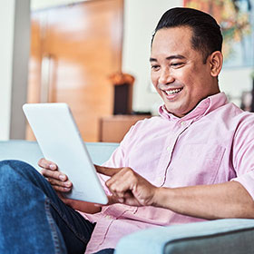 Photo of a man looking at a tablet. Link to Life Stage Gift Planner Under Age 60 Situations.