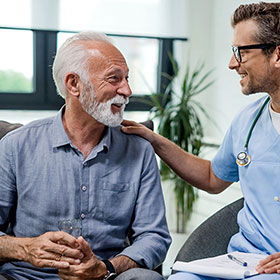 Photo of a patient and a doctor. Link to Life Stage Gift Planner Over Age 70 Situations.